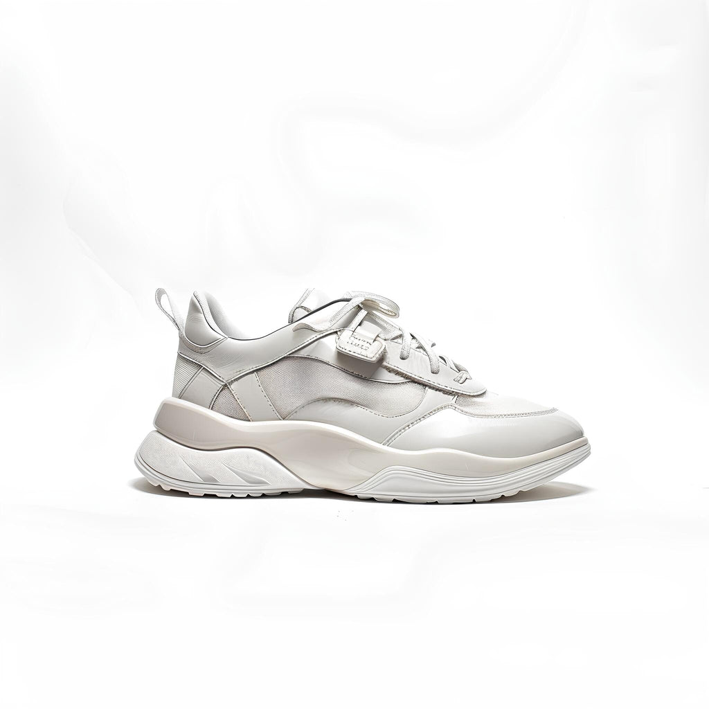 White chunky sneaker with glossy and textured panels, featuring a thick, sculpted sole.